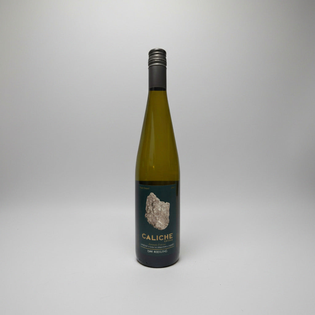 Wine bottle with 'Caliche' label on a white background